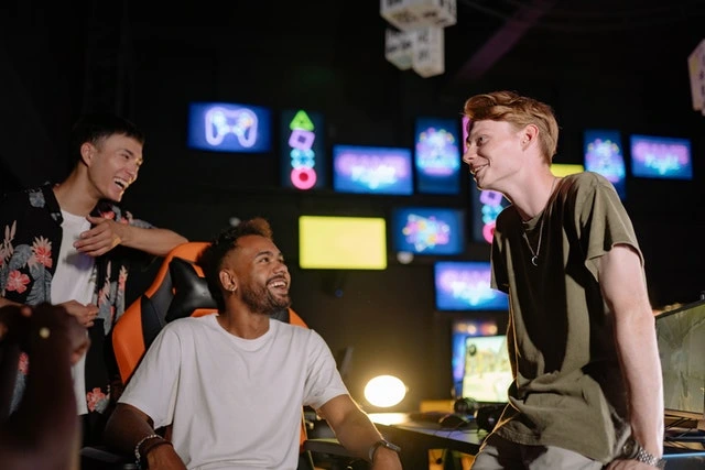 Three males talking and laughing